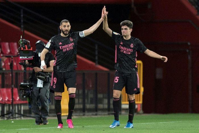 Real Madrid's Karim Benzema (left) celebrates scoring a goal with 19-year-old defender Miguel Gutierrez against Granada on Thursday.