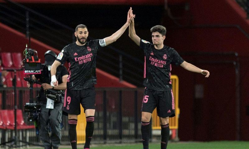 Real Madrid's Karim Benzema (left) celebrates scoring a goal with 19-year-old defender Miguel Gutierrez against Granada on Thursday.