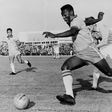 In this photo taken on May 8, 1960, Brazilian football legend Pele dribbles past a defender during a friendly match between Malmoe and Brazil, in Sweden