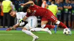 Mo Salah (right) is pulled to the ground by Sergio Ramos leading to a dislocated shoulder during the 2018 Champions League final in Kiev