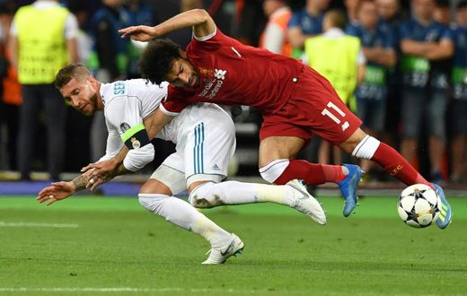 Mo Salah (right) is pulled to the ground by Sergio Ramos leading to a dislocated shoulder during the 2018 Champions League final in Kiev