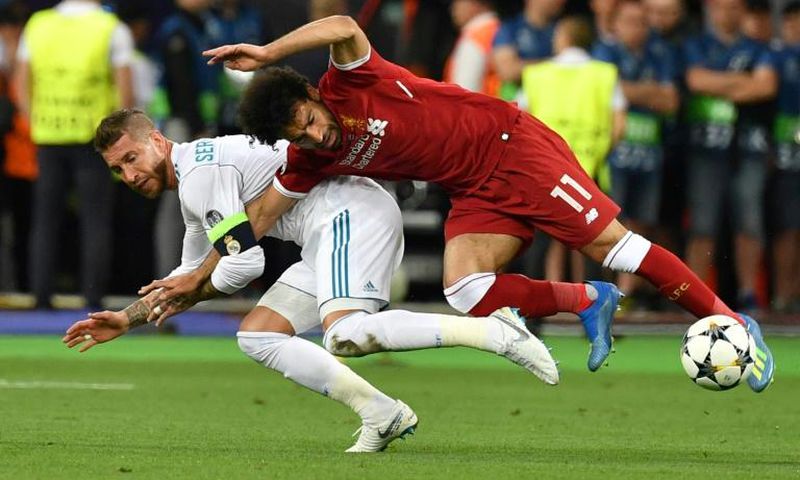 Mo Salah (right) is pulled to the ground by Sergio Ramos leading to a dislocated shoulder during the 2018 Champions League final in Kiev