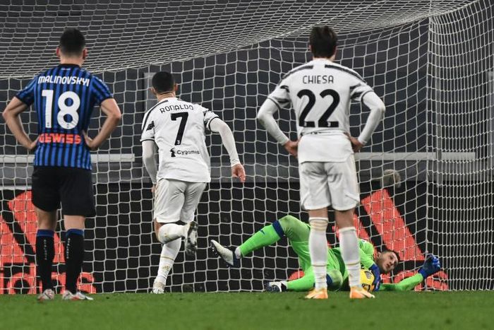 Atalanta goalkeeper Pierluigi Gollini (Rear Bottom) saves a Cristiano Ronaldo (2ndL) penalty in Turin.