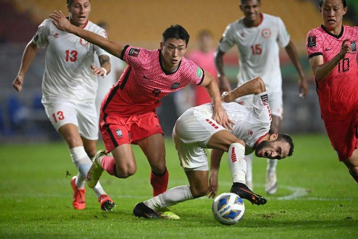 South Korea's Cho Gue-sung (left) competes for the ball with Lebanon's Abbas Asi
