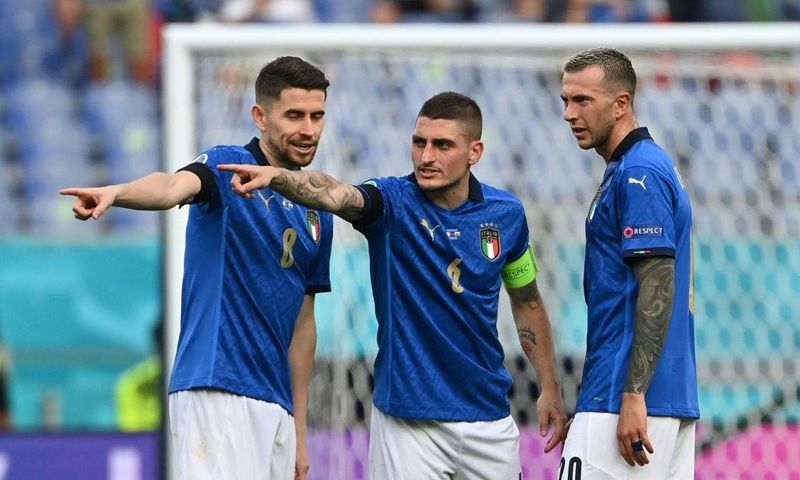 (L to R): Italy's Jorginho, Marco Verratti and Federico Bernardeschi plot victory against Wales