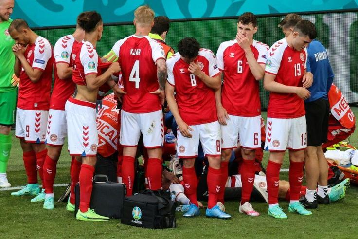 Denmark players formed a circle around Christian Eriksen (not seen) as paramedics saved his life during Euro 2020