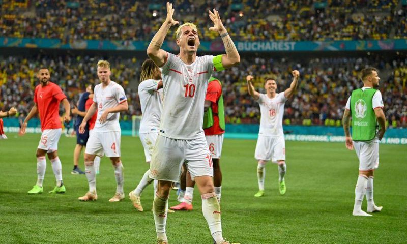 Switzerland's Granit Xhaka leads the celebrations after their victory over the world champions