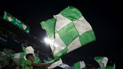 Real Betis' supporters wave flags before the start of the Seville derby against Sevilla on Sunday.