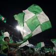 Real Betis' supporters wave flags before the start of the Seville derby against Sevilla on Sunday.