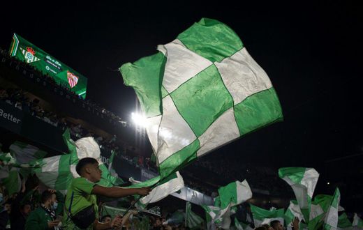 Real Betis' supporters wave flags before the start of the Seville derby against Sevilla on Sunday.