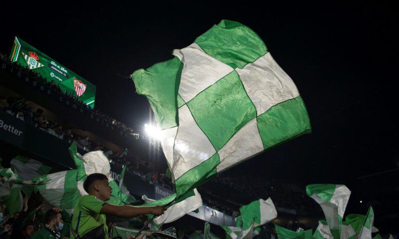 Real Betis' supporters wave flags before the start of the Seville derby against Sevilla on Sunday.
