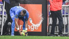 Marseille's French midfielder Dimitri Payet (left) was hit by a bottle of water thrown from the stands during the Ligue 1 match against Lyon