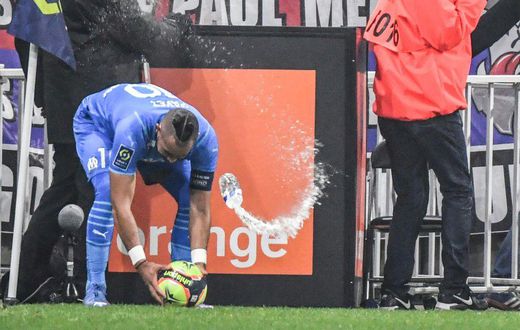 Marseille's French midfielder Dimitri Payet (left) was hit by a bottle of water thrown from the stands during the Ligue 1 match against Lyon