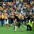 Lens supporters invade the pitch at half-time of the northern derby against Lille