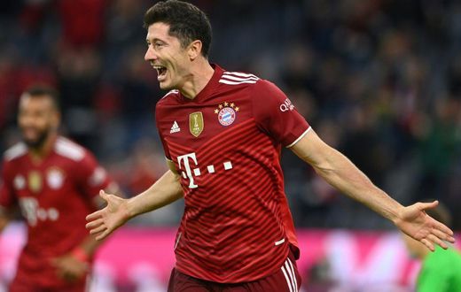 Bayern Munich striker Robert Lewandowski celebrates his hat-trick in the 5-0 thrashing of Hertha Berlin