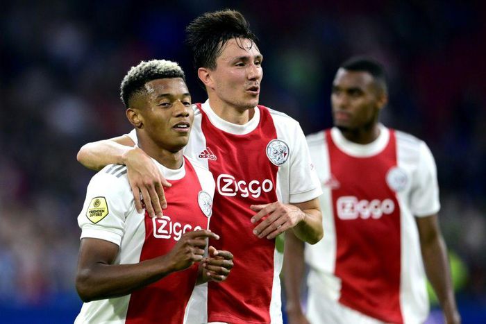 Easy does it: Ajax's David Neres and Steven Berghuis celebrate their fourth goal