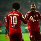 Bayern Munic striker Eric Maxim Choupo-Moting (R) celebrates scoring against Bremer with Leroy Sane