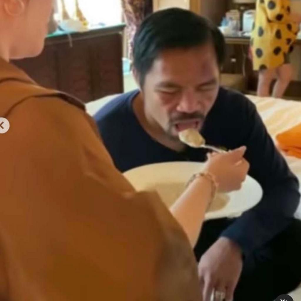 Manny Pacquiao being spoon-fed by his wife