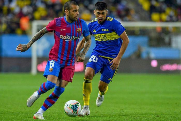 Barcelona's Dani Alves (L) vies for the ball with Boca Juniors' Juan Edgardo Ramirez in the inaugural Maradona Cup friendly in Riyadh.