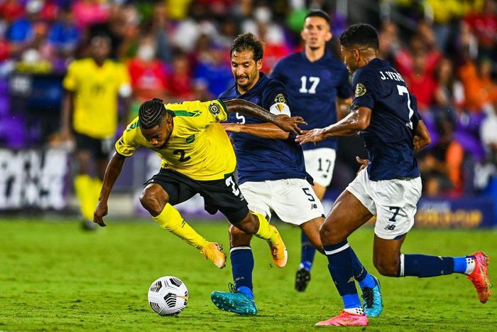 Jamaica's Lamar Walker (left) stumbles as he fights for the ball during the CONCACAF Gold Cup football match between Costa Rica and Jamaica in Orlando, Florida