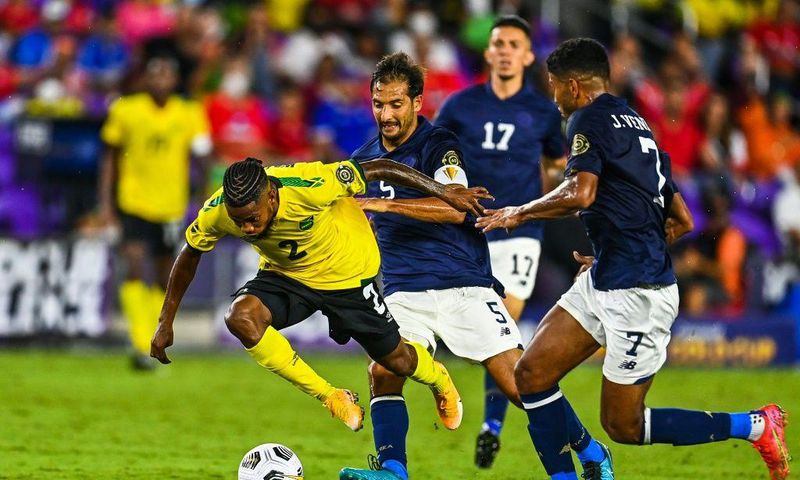 Jamaica's Lamar Walker (left) stumbles as he fights for the ball during the CONCACAF Gold Cup football match between Costa Rica and Jamaica in Orlando, Florida