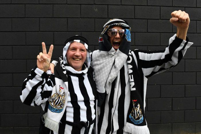 Newcastle fans pose in Arab-style clothing at St James' Park