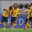 Awer Mabil (L) celebrates with teammates after scoring the opener against China
