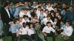 Bernard Tapie, in shirt and tie behind the trophy, poses with the Marseille players who won the 1993 European Cup