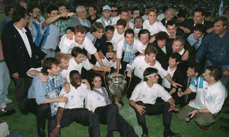 Bernard Tapie, in shirt and tie behind the trophy, poses with the Marseille players who won the 1993 European Cup