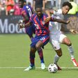 US defender Shaquell Moore, left, and Canada forward Tajon Buchanan battle for the ball during their CONCACAF Gold Cup match in Kansas City, Kansas