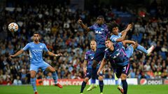 Tinged with sadness: Manchester City's Dutch defender Nathan Ake  jumps to head the ball home