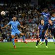 Tinged with sadness: Manchester City's Dutch defender Nathan Ake  jumps to head the ball home