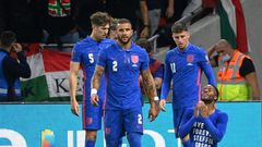 England's forward Raheem Sterling (R) celebrates his opening goal, with a cup thrown by Hungary fans in the background