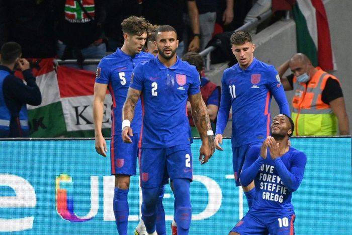 England's forward Raheem Sterling (R) celebrates his opening goal, with a cup thrown by Hungary fans in the background