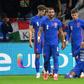 England's forward Raheem Sterling (R) celebrates his opening goal, with a cup thrown by Hungary fans in the background
