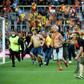 Lens fans run onto the pitch during half-time of the Ligue 1 game against Lille