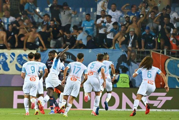 Comeback kings: Marseille celebrate their 3-2 win at Montpellier