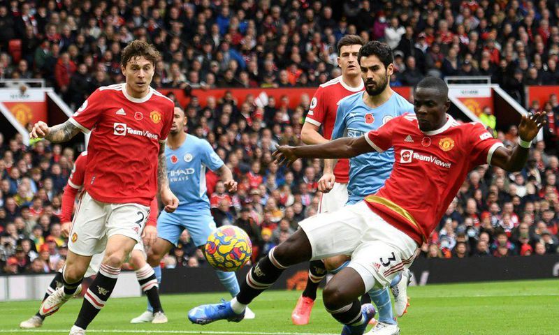 Manchester United centre-back Eric Bailly (R) concedes an own-goal against Manchester City at Old Trafford.