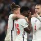 England's football team has united against raciism, Here midfielder Bukayo Saka (c) is consoled after failing to score in the penalty shootout of the Eur2020 final which England lost against Italy on Sunday