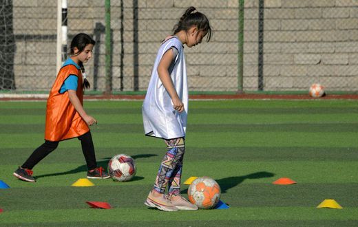 Iraqi girls take part in a football training session at the Bartalla sports club, in the former jihadist stronghold of Bartalla