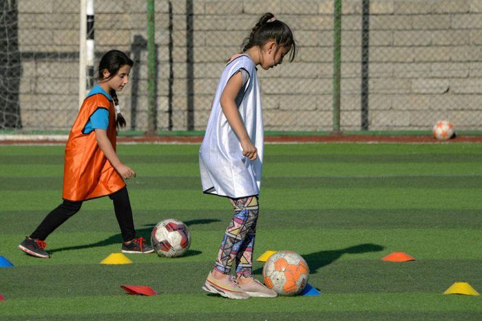 Iraqi girls take part in a football training session at the Bartalla sports club, in the former jihadist stronghold of Bartalla