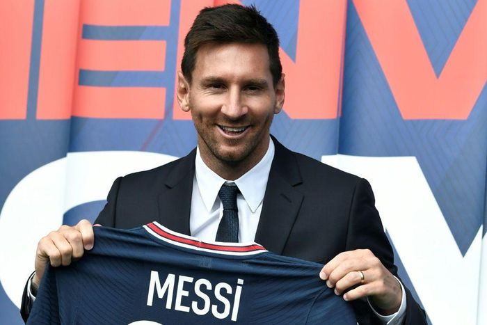 Welcome to Paris: Lionel Messi poses as he holds-up his number 30 shirt