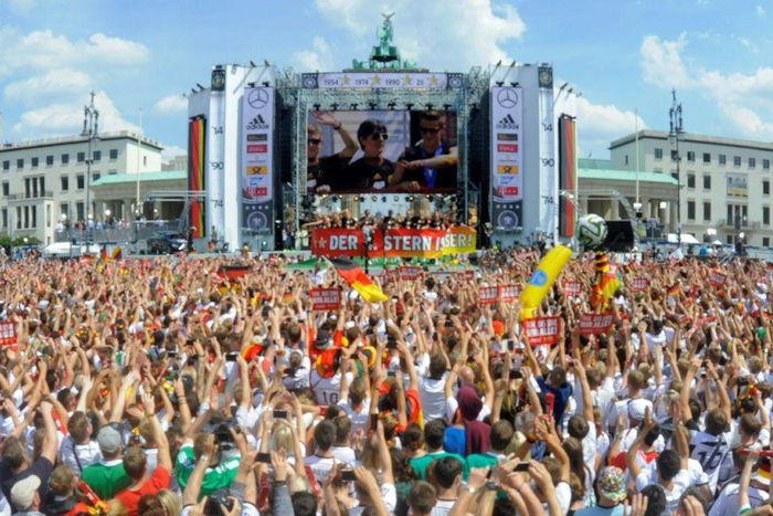 Germany head coach Joachim Loew is displayed on a giant screen as thousands of football fans in Berlin celebrate Germany's win at the 2014 World Cup
