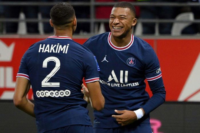 Kylian Mbappe celebrates with Achraf Hakimi after scoring PSG's second goal against Reims