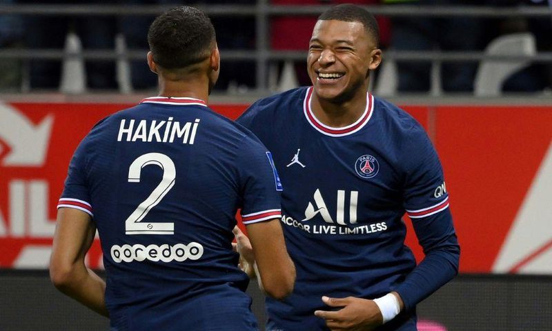 Kylian Mbappe celebrates with Achraf Hakimi after scoring PSG's second goal against Reims