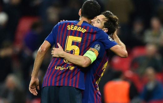 Sergio Busquets congratulates Lionel Messi on a Champions League goal in 2018