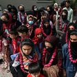 The team wore garlands and dressed in burqas as they arrived at the Pakistan Football Federation in Lahore