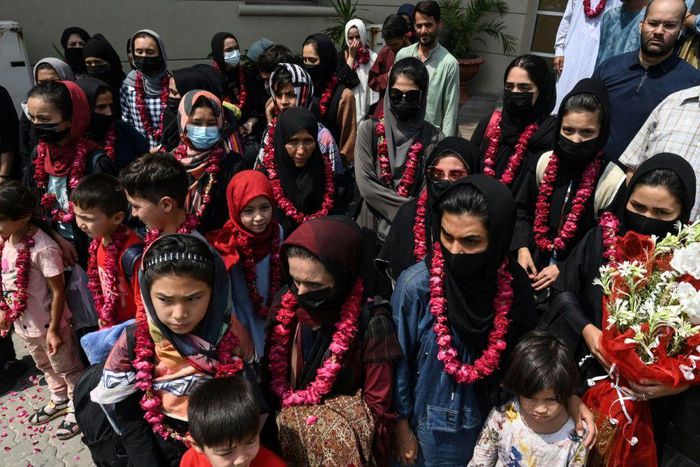 The team wore garlands and dressed in burqas as they arrived at the Pakistan Football Federation in Lahore