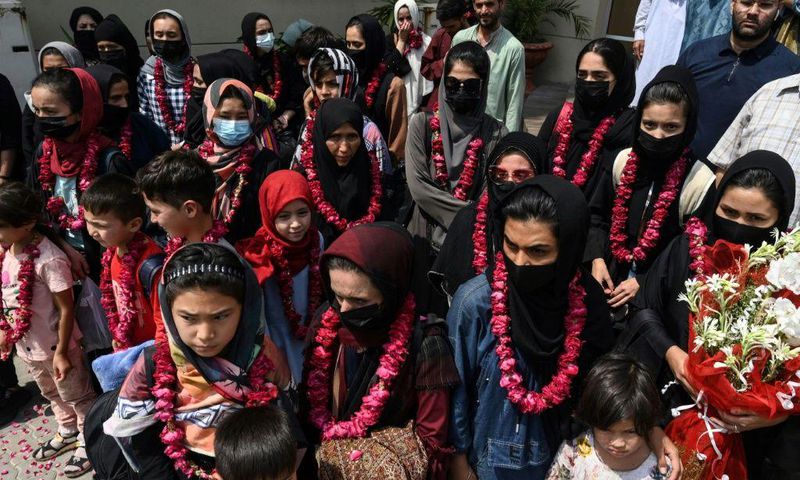 The team wore garlands and dressed in burqas as they arrived at the Pakistan Football Federation in Lahore