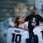 Walter Rotundo, a huge fan of the late Diego Maradona, poses with his daughters Mara (L) and Dona (R)